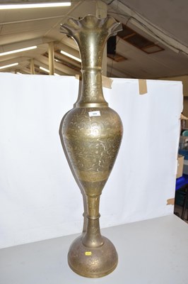 Lot 555 - A large brass floor standing vase