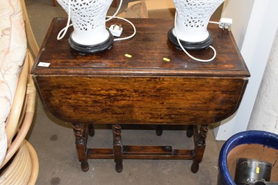 Lot 722 - An oak table on barley twist legs