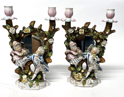 Lot 230 - A pair of continental porcelain candlesticks...