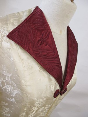 Lot 17 - An early 20th century cream and burgundy satin...