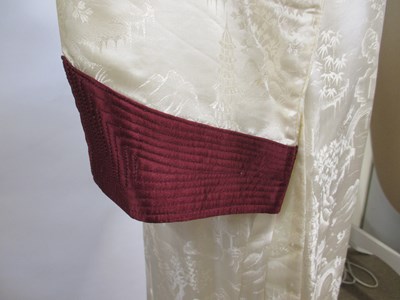 Lot 17 - An early 20th century cream and burgundy satin...