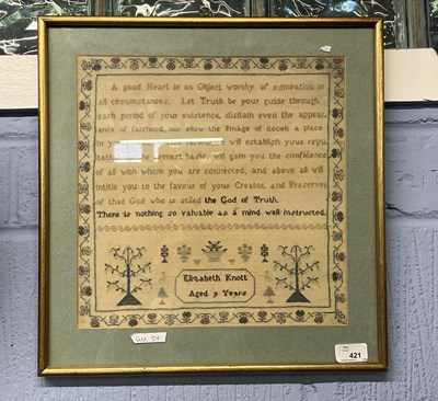 Lot 421 - A framed sampler with rows of religious text...