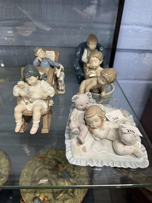 Lot 276 - Group of Lladro models of children seated in...