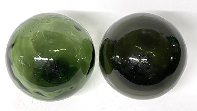 Lot 278 - Two green glass witches balls