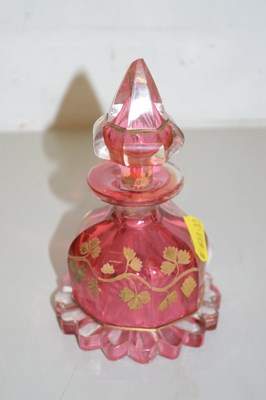 Lot 61 - A cranberry glass and gilt decorated scent bottle