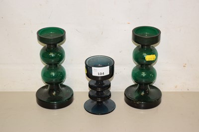 Lot 104 - A pair of green glass candlesticks and one other