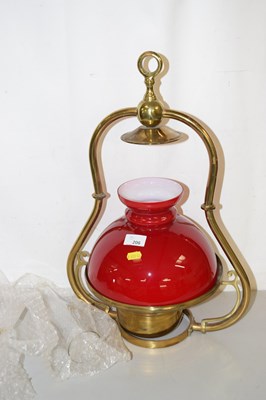 Lot 206 - A hanging oil lamp with red glass shade