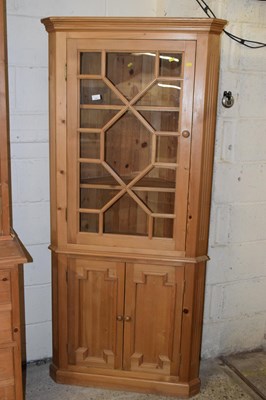 Lot 234 - A modern pine corner cabinet with moulded...