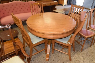 Lot 284 - A round pedestal pine kitchen table and four...