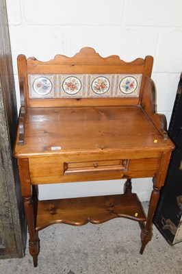 Lot 343 - A small pine wash stand with tiled back