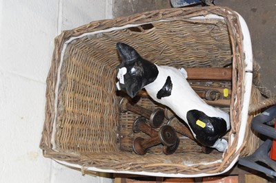 Lot 881 - A wicker basket containing a model terrier and...