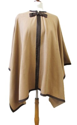 Lot 135 - A camel coloured wool and faux leather cape,...