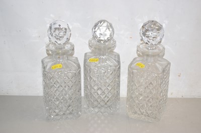 Lot 9 - Set of three clear glass spirit decanters