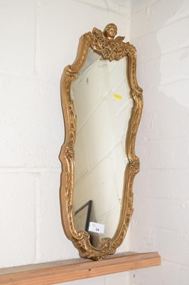 Lot 34 - A modern gilt framed wall mirror with cherub...