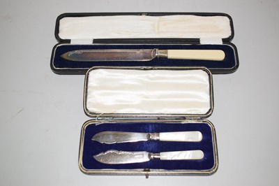 Lot 115 - Two mother of pearl handled butter knives in...