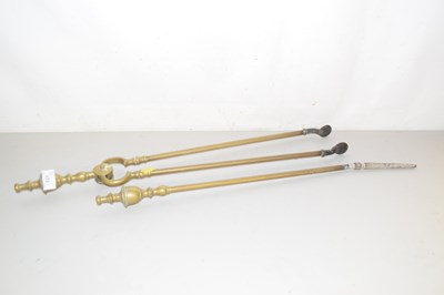 Lot 172 - Brass fire poker and tongs