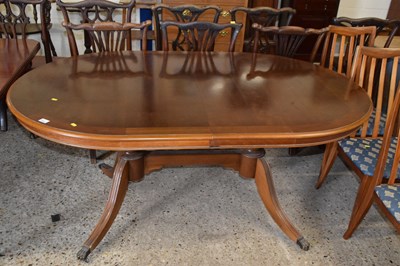 Lot 263 - A reproduction extending twin pedestal dining...