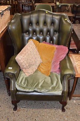 Lot 275 - A leather Chesterfield button back wing chair,...