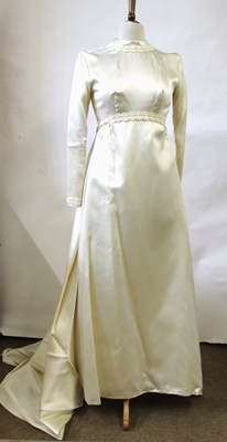 Lot 33 - A 1960's wedding dress, in cream satin with...