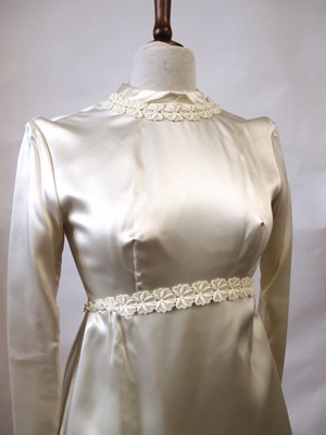 Lot 33 - A 1960's wedding dress, in cream satin with...