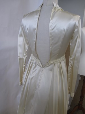 Lot 33 - A 1960's wedding dress, in cream satin with...