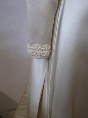Lot 33 - A 1960's wedding dress, in cream satin with...
