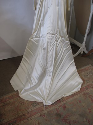 Lot 33 - A 1960's wedding dress, in cream satin with...