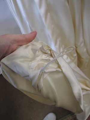 Lot 33 - A 1960's wedding dress, in cream satin with...