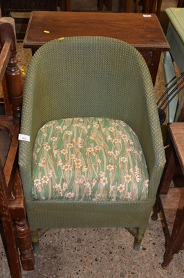 Lot 303 - A Lloyd Loom style chair with floral...