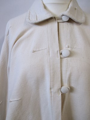 Lot 80 - A cream cotton cape by Lydia G, with button...