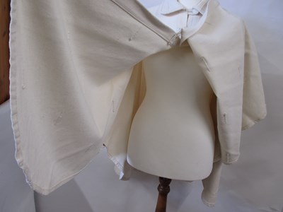 Lot 80 - A cream cotton cape by Lydia G, with button...