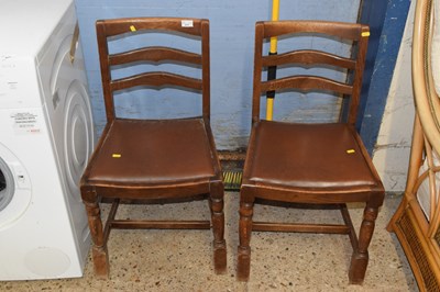 Lot 217 - A pair of oak ladder back chairs
