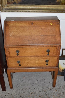 Lot 246 - An early 20th Century oak two door bureau