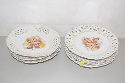 Lot 548 - A group of six cherub decorated wall plates...