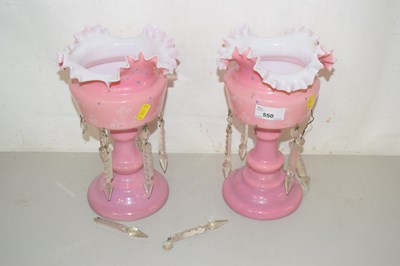 Lot 550 - A pair of pink glass lustre vases
