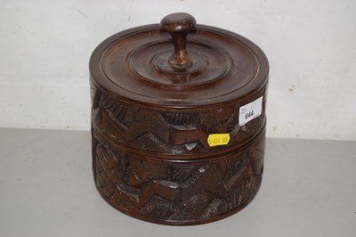 Lot 644 - An African hardwood container with carved...
