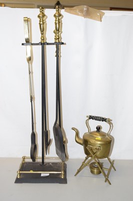 Lot 684 - A fire tool set and a spirit kettle