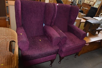 Lot 891 - A pair of plum upholstered wing back armchairs