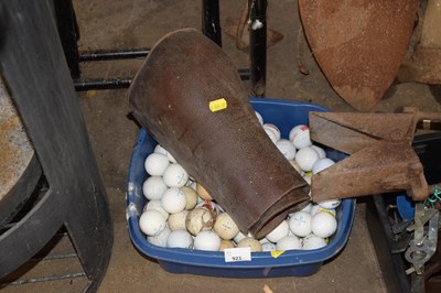Lot 921 - A bowl of golf balls and leather chaps