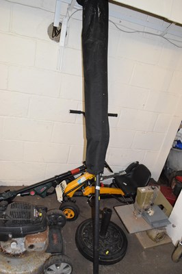 Lot 942 - A garden parasol with stand