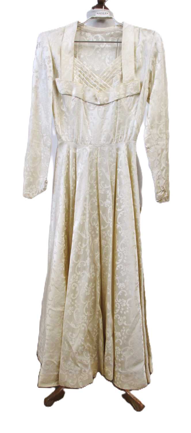 Lot 23 - A 1940's cream patterned satin wedding...