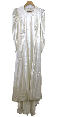 Lot 24 - A mid 20th century wedding dress, the cream...