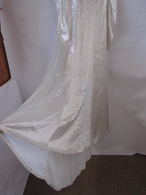 Lot 24 - A mid 20th century wedding dress, the cream...