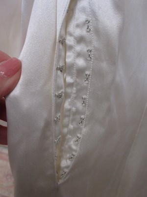 Lot 24 - A mid 20th century wedding dress, the cream...