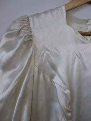 Lot 24 - A mid 20th century wedding dress, the cream...