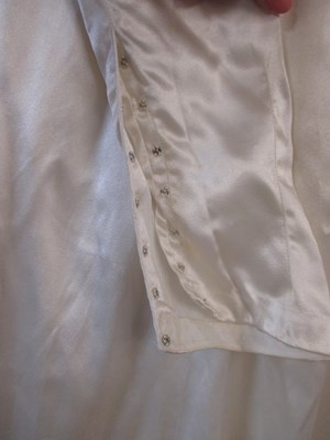 Lot 24 - A mid 20th century wedding dress, the cream...