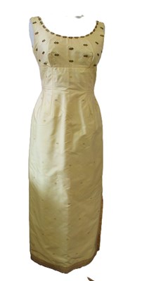 Lot 91 - A buttermilk yellow silk two piece by Gosden,...