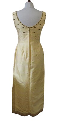 Lot 91 - A buttermilk yellow silk two piece by Gosden,...