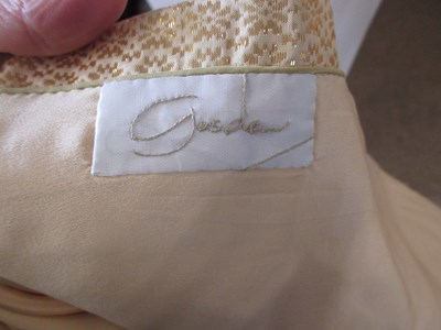 Lot 91 - A buttermilk yellow silk two piece by Gosden,...