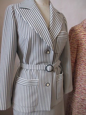 Lot 42 - Two c.1970's skirt suits, including a navy and...